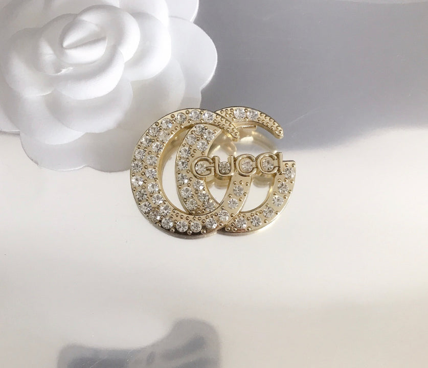 GG gold brooch